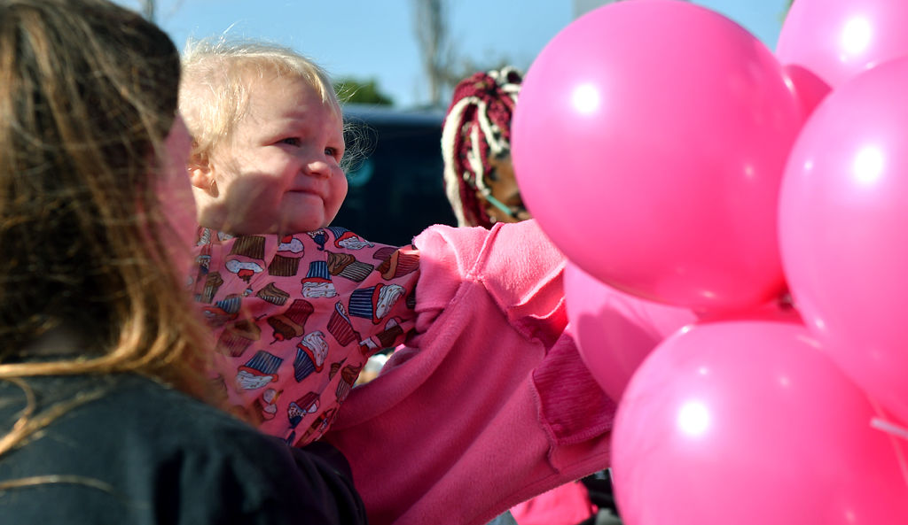Aminah Curry reaches out to touch balloons on Friday at Battle High School in Columbia.